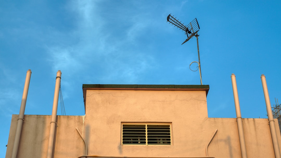 our-story a-tall-building-with-a-weather-vane-on-top-of-it-e8g1qnrfw44